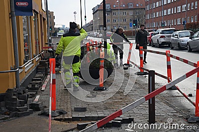 Bricklayer working on footpath at Kastruplundgade in capital Editorial Stock Photo