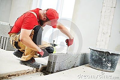 Bricklayer builder working with ceramsite concrete blocks. Walling Stock Photo
