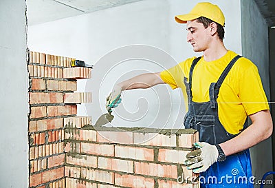 Bricklaying. Construction worker building a brick wall Stock Photo