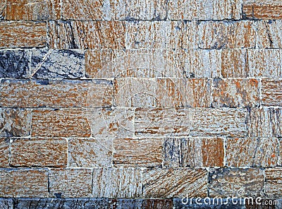 Bricks of concrete blocks textured orange and blue gray stones wall pattern Stock Photo