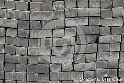 Bricks paving stones on pallets, background texture close-up Cobblestones paving roads, materials for construction Stock Photo