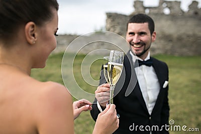 Bridal couple clink glasses of champagne Stock Photo