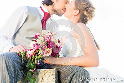 Bridal pair kissing on field Stock Photo