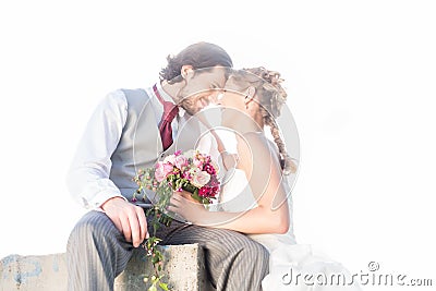 Bridal pair kissing on field after wedding Stock Photo