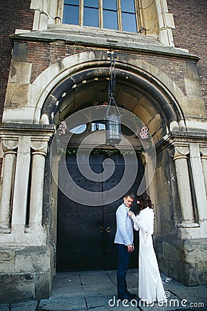 Bride adjust a lily on fiance's jacket Stock Photo