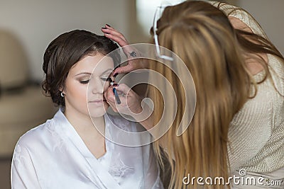 Bride applying wedding make-up Stock Photo