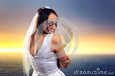 Bride on the background of the sea and sunset Stock Photo