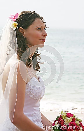 Bride on Beach with Bouquet Stock Photo