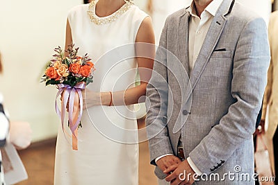 Bride with bouquet and groom at wedding registry. stylish couple Stock Photo