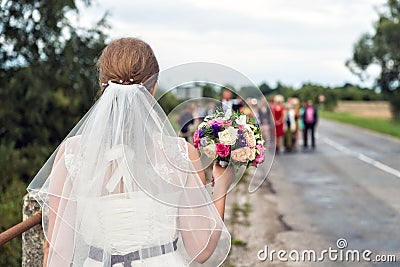 Bride with bridal bouquet in the hands of the groom expect. Stock Photo