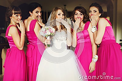 Bride and bridesmaids flirt standing in the restaurant Stock Photo