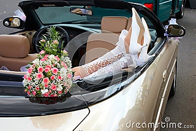 Bride in a cabriolet with flowers Stock Photo