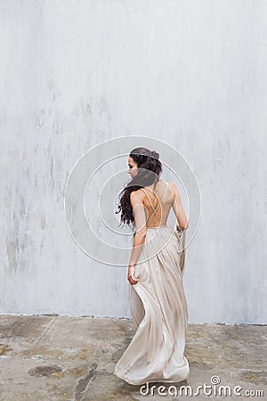 Bride dancing in a long gentle silk dress fine art trendy style. Pastel color Stock Photo