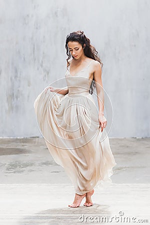 Bride dancing in a long gentle silk dress fine art trendy style. Pastel color Stock Photo