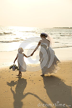 Bride and flower girl walking Stock Photo