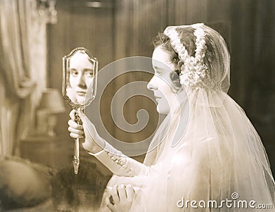 Bride gazing into hand mirror Stock Photo