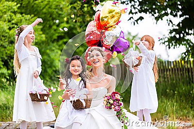 Bride with girls as bridesmaids, flowers and balloons Stock Photo