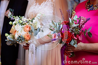 Bride and godmother holding wedding bouquets during wedding ceremony Stock Photo