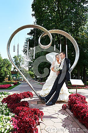 Bride and groom about art ironwork Stock Photo