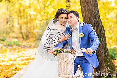 Bride and groom in autumn park Stock Photo