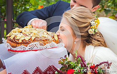 Bride and groom being met by parents with bread Stock Photo