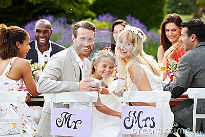 Bride And Groom With Bridesmaid At Wedding Reception Stock Photo