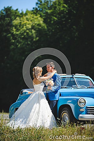 Bride and Groom by Cabriolet Stock Photo