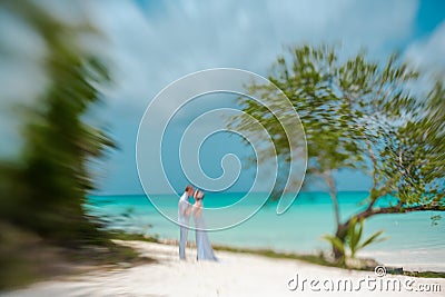 Bride and groom on a Caribbean beach, Lensbaby artistic blur, Stock Photo