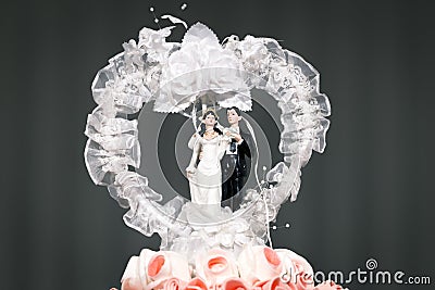 Bride and groom couple doll on wedding cake. Stock Photo