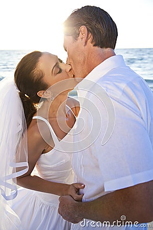 Bride & Groom Couple Kissing Sunset Beach Wedding Stock Photo