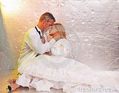 Bride and groom embrace Stock Photo