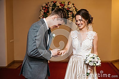 The bride and groom are exchanging wedding rings in the registry office Stock Photo