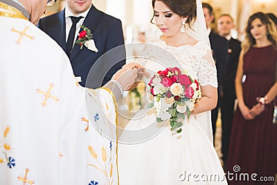 Bride and groom exchanging wedding rings. Stylish couple official ceremony Stock Photo