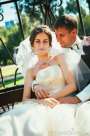 The bride and groom in the gazebo in the park Stock Photo