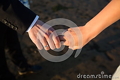 A pair of hands hold each other Stock Photo