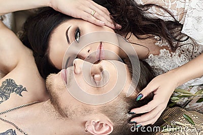 Bride and groom are getting ready in the morning for the wedding. Loving couple hugging at home. Handsome groom and charming bride Stock Photo
