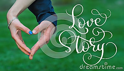 Bride and groom hands making heart and vintage text Love story. Calligraphy lettering hand draw Stock Photo