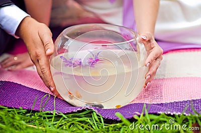 Bride and groom holding aquarium with goldfish Stock Photo