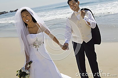 Bride and Groom holding hands Stock Photo