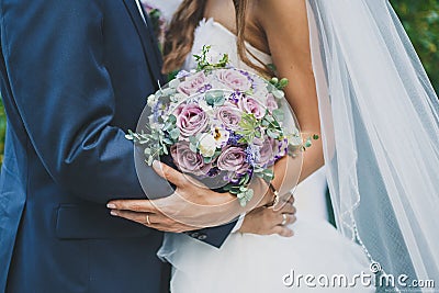 the bride and groom are holding a wedding bouquet Stock Photo