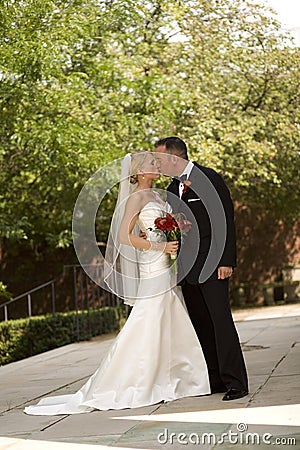 Bride and Groom Kissing Stock Photo