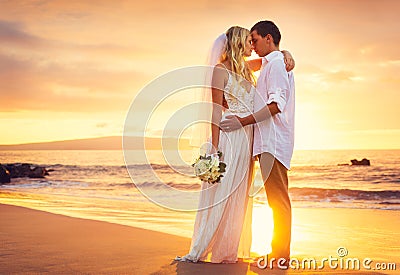 Bride and Groom, Kissing at Sunset on a Beautiful Tropical Beach Stock Photo