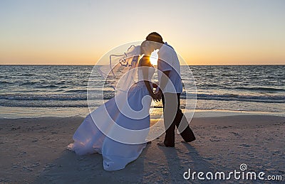 Bride and Groom Married Couple Sunset Beach Wedding Stock Photo