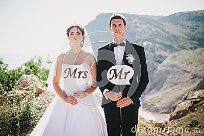 Bride and groom with Mr and Mrs signs Stock Photo