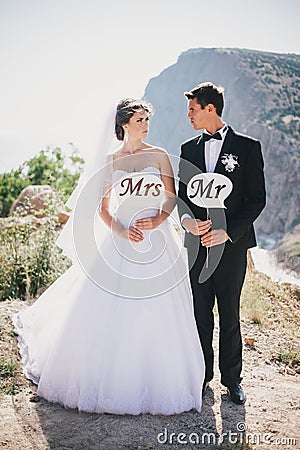 Bride and groom with Mr and Mrs signs Stock Photo