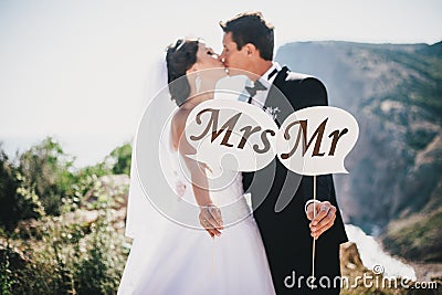 Bride and groom with Mr and Mrs signs Stock Photo