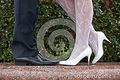 Bride and groom shoes closeup on marble on nature background. Stock Photo