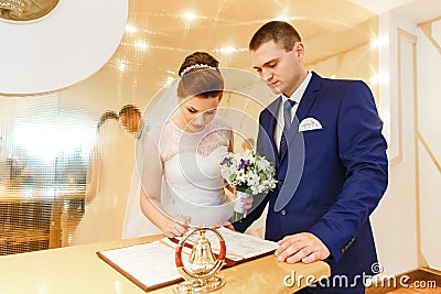 Bride and groom signing marriage license Stock Photo