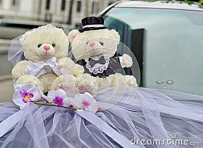 Bride and groom Teddy wedding bears attached to the car Stock Photo