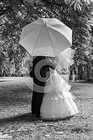 Bride and groom with white umbrella Stock Photo